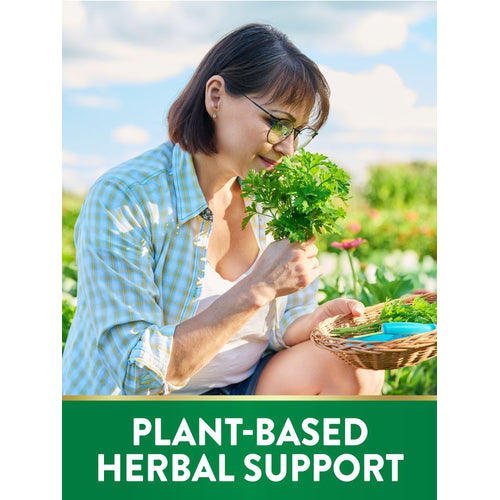 Middle-aged woman in garden smelling parsley, holding a herb basket. Text on image: PLANT-BASED HERBAL SUPPORT.