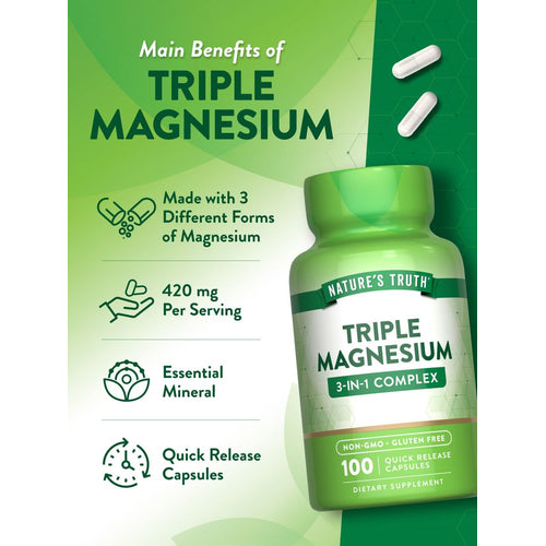 A hand holding two white Triple Magnesium 420 mg Per Serving Quick Release capsules.