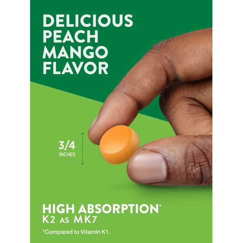 An orange gummy held between fingers, illustrating its 3/4-inch size.