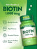 Two round white Biotin 1,000 mcg tablets on a hand scale.