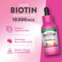 Nature's Truth Liquid Biotin Collagen + HA, 10,000 mcg, Orange Creamsicle flavor, 2 fl. oz (59 mL) bottle on hand scale.