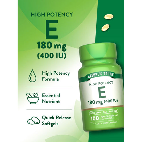 Two golden quick release softgels of Vitamin E, 180 mg (400 IU), are shown on a hand for size reference.