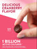 A round cranberry-flavored gummy measuring 3/4 inch in diameter rests on a hand scale for bulk measurement.