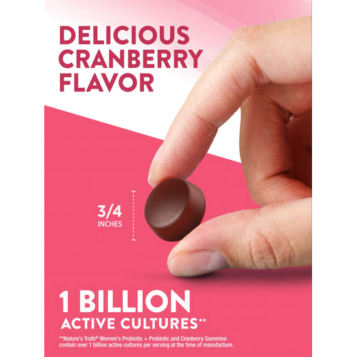A round cranberry-flavored gummy measuring 3/4 inch in diameter rests on a hand scale for bulk measurement.