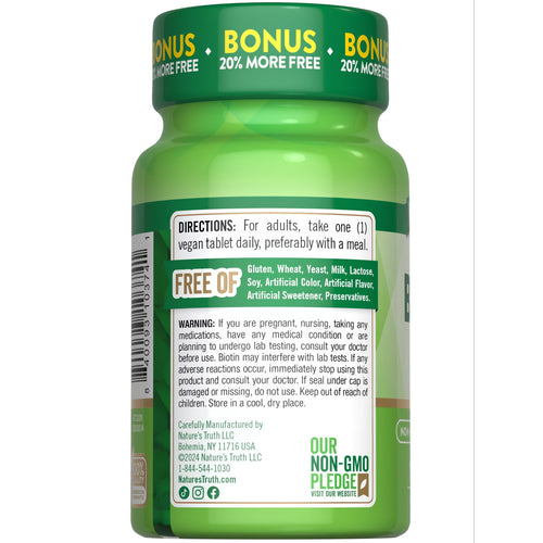 A hand holding a bulk scale container of 1000 mcg biotin vegan tablets.