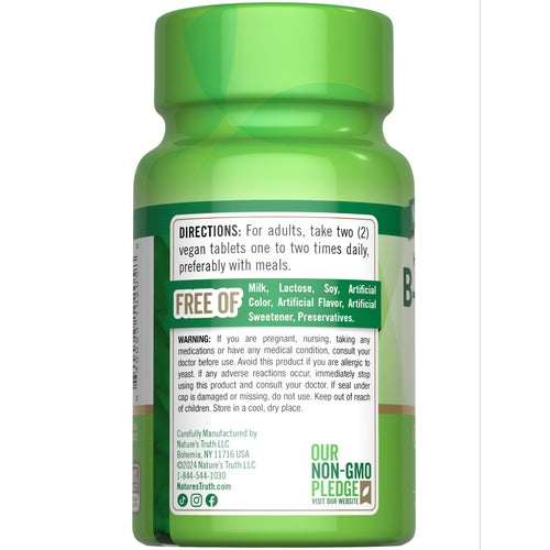 Hand holding NT B-Complex + B-12 bottle with 90 vegan tablets.