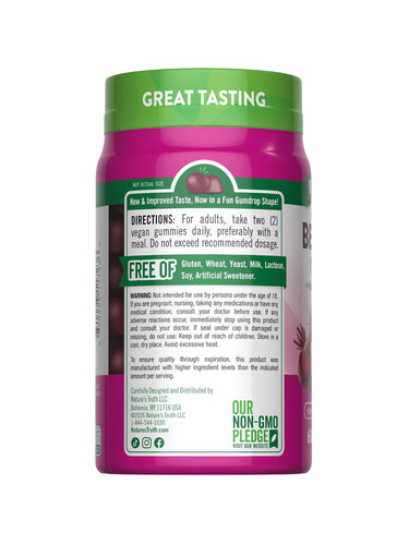 Hand holding a bottle of 60 vegan beet root gummies shaped like gumdrops, showcasing their size and fun design.