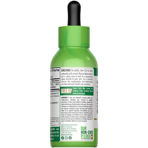 A 2.5 OZ bottle of liquid Vitamin E Oil displayed on a hand scale with bulk measurement markings.