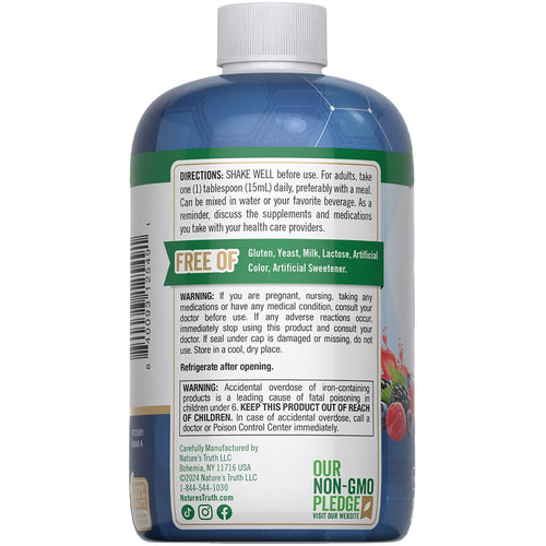A hand holding an NT Liquid Iron 8 fl oz bottle on a scale.