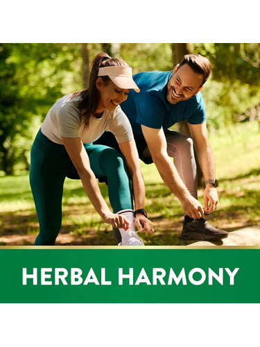 A young adult couple ties their shoelaces outdoors beside a green banner stating 'HERBAL HARMONY'.