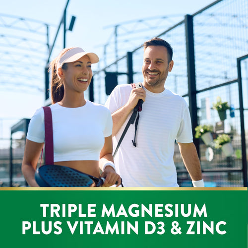 Text 'TRIPLE MAGNESIUM PLUS VITAMIN D3 & ZINC' over a man and woman walking and smiling at a sports court.