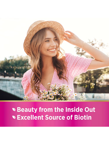A young woman smiles outdoors, holding a straw hat and flowers, with NT Hair, Skin, Nails.