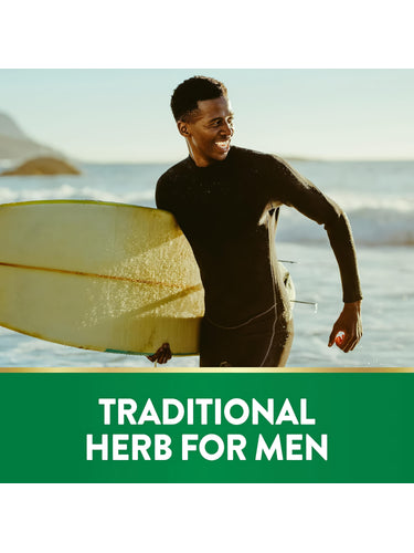 Young adult Black man in wetsuit, smiling with a surfboard on the beach. Text reads 'TRADITIONAL HERB FOR MEN'.