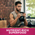 Young adult male holding a kettlebell in a squat stance at a gym with 'Nutrient-Rich Superfood' text overlay.