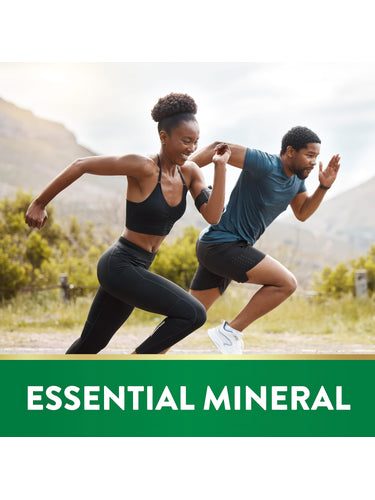 A young adult woman and man sprinting outdoors under a banner that reads 'ESSENTIAL MINERAL'.