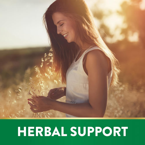 A young woman smiles while touching tall grasses in a sunlit field, symbolizing Rhodiola Rosea.