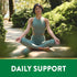 An adult woman meditates in a garden with the text 'DAILY SUPPORT' visible.