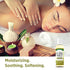 A woman enjoys a massage with spa essentials and a bottle of E-Oil 30,000 IU nearby.