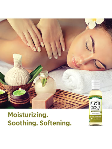A woman enjoys a massage with spa essentials and a bottle of E-Oil 30,000 IU nearby.