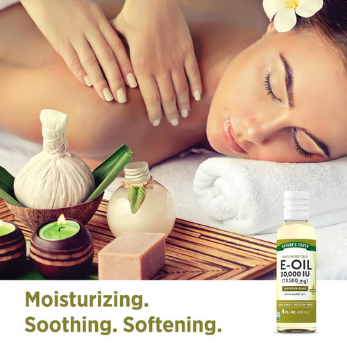 A woman enjoys a massage with spa essentials and a bottle of E-Oil 30,000 IU nearby.