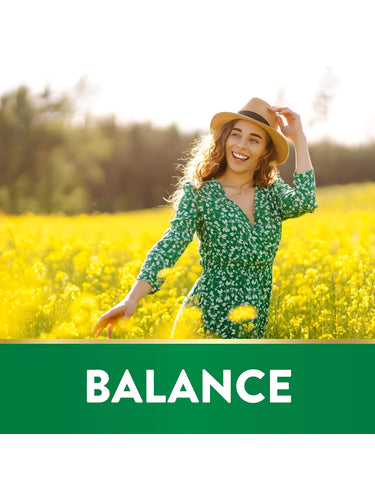 A woman smiles in a yellow flower field with 'BALANCE' text, featuring St. John's Wort.