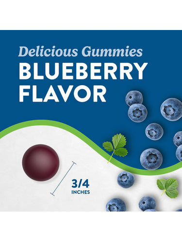 A 3/4-inch blueberry flavor gummy next to fresh blueberries.