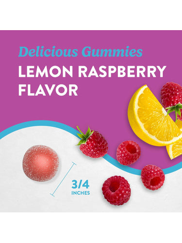 Lemon Raspberry magnesium gummy, 3/4 inches in size, next to fresh raspberries and lemon slices.