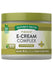 Hand holding E-Cream Complex skin care cream, 4 oz (113 g), showcasing the product's size and design.