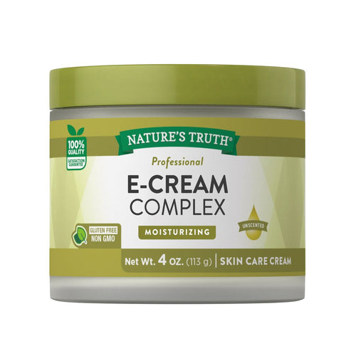 Hand holding E-Cream Complex skin care cream, 4 oz (113 g), showcasing the product's size and design.