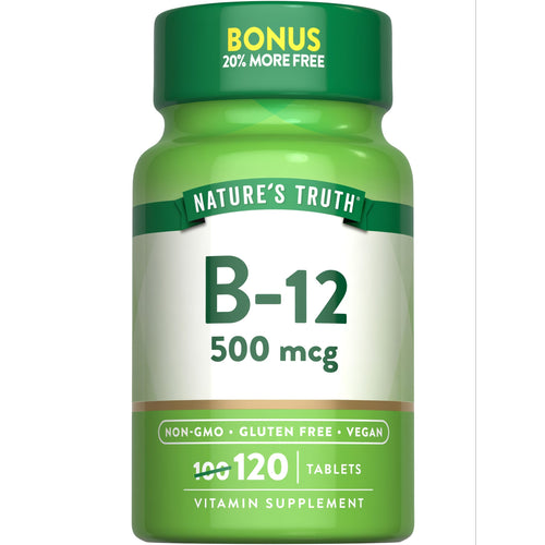 A hand holding a bottle of B-12 500 mcg, containing 120 tablets, photographed on a scale for size comparison.