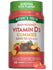 Two orange Vitamin D3 gummies, providing 5,000 IU (125 mcg) each, rest on a bulk scale.