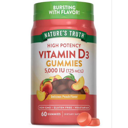 Two orange Vitamin D3 gummies, providing 5,000 IU (125 mcg) each, rest on a bulk scale.
