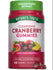 Two red, circular gummies are displayed next to the product bottle.