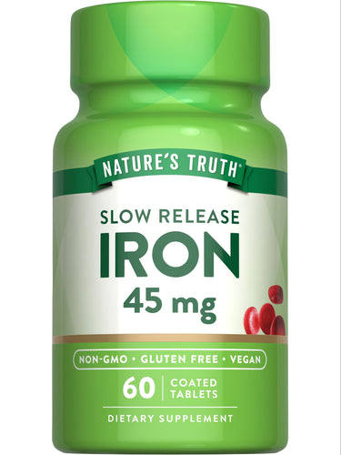 Hand holding a bottle of slow release iron tablets, 45 mg, 60 coated tablets, emphasizing dietary supplement and iron dosage.