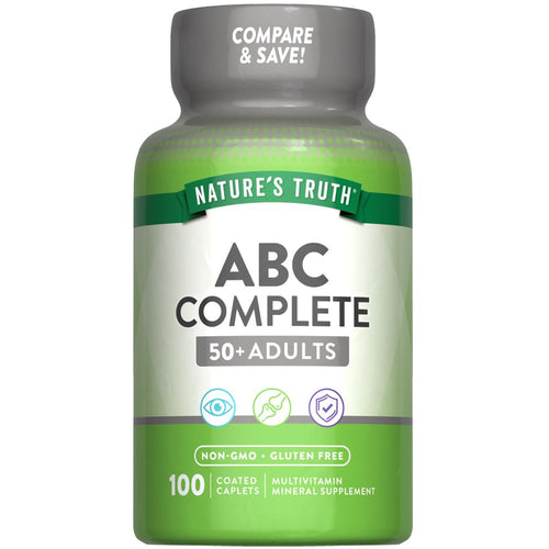 A bottle of ABC Complete 50+ Adults Multivitamin Mineral Supplement with 100 coated caplets shown on a hand scale.