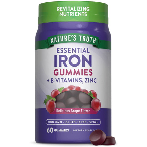 Two round, dark purple Essential Iron Gummies with B-Vitamins and Zinc on a hand scale.