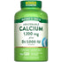 Hand holding Quick Release Softgels with Calcium 1,200 mg and Vitamin D3 5,000 IU.