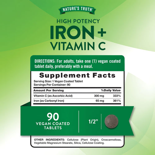 A single vegan-coated tablet, half an inch in size, shown on a hand scale, emphasizing its small and compact form.