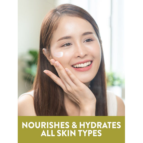Young woman applying NT JW Vitamin E-Cream to cheek. Graphic text reads: Nourishes and hydrates all skin types.