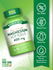 A hand holding a bottle of Magnesium Softgels, 400 mg, 72 count, showcasing the product size and packaging.