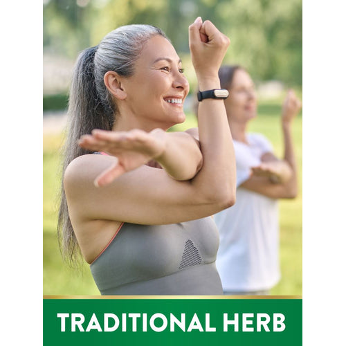 View 4 Adult woman with grey hair smiling and stretching outdoors, with a second woman blurred in background. Text banner: TRADITIONAL HERB.