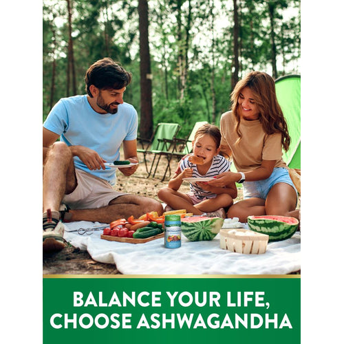 A family enjoying an outdoor picnic with fruits, vegetables, and a bottle of Ashwagandha Gummies on the grass.