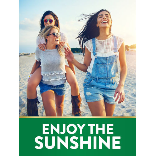 Three young women laughing and giving piggyback rides on a sandy beach. Graphic banner reads: 'ENJOY THE SUNSHINE'.