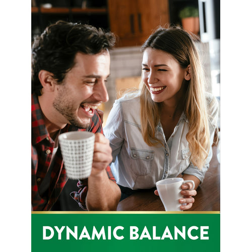 Man and woman laughing while holding mugs. A green banner at the bottom reads 'DYNAMIC BALANCE'.