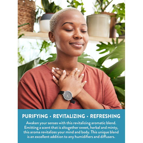 Young adult woman with eyes closed, hands on chest, surrounded by plants. Text: Purifying, Revitalizing, Refreshing aromatic blend for diffusers.