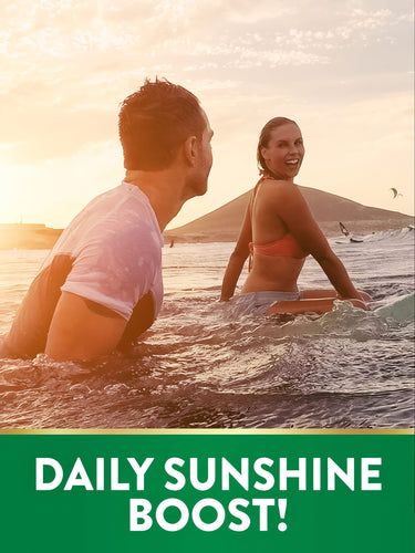 Young man and woman surfing in the ocean at sunset with graphic text 'DAILY SUNSHINE BOOST!', NT D3.