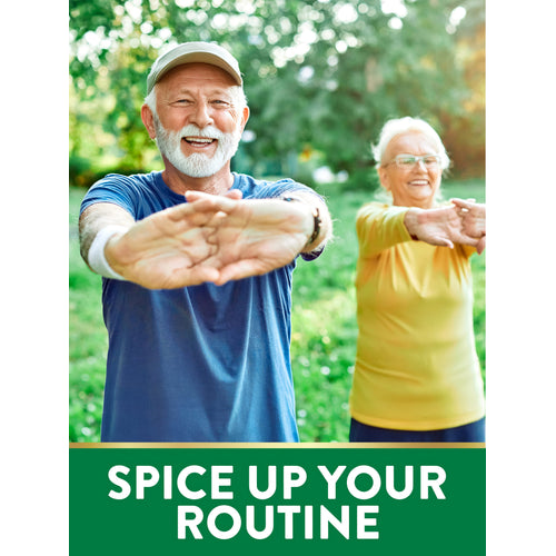 Senior couple in athletic wear smiling while stretching their arms outdoors in a sunny park.