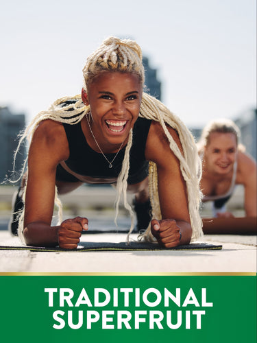 Two young women exercising in plank position on yoga mats, with overlaid text 'TRADITIONAL SUPERFRUIT'.