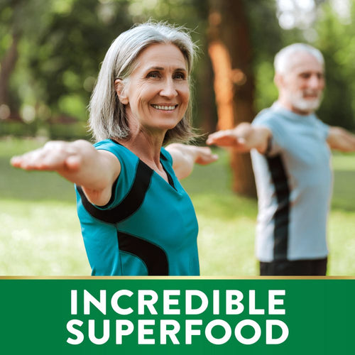 Senior woman and man doing yoga outdoors, with a green banner at the bottom stating 'INCREDIBLE SUPERFOOD'.