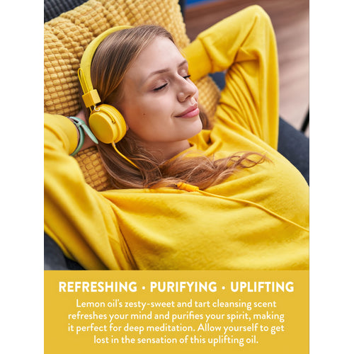 Young woman relaxing with eyes closed, wearing yellow headphones, enjoying refreshing, purifying, uplifting Lemon oil.
